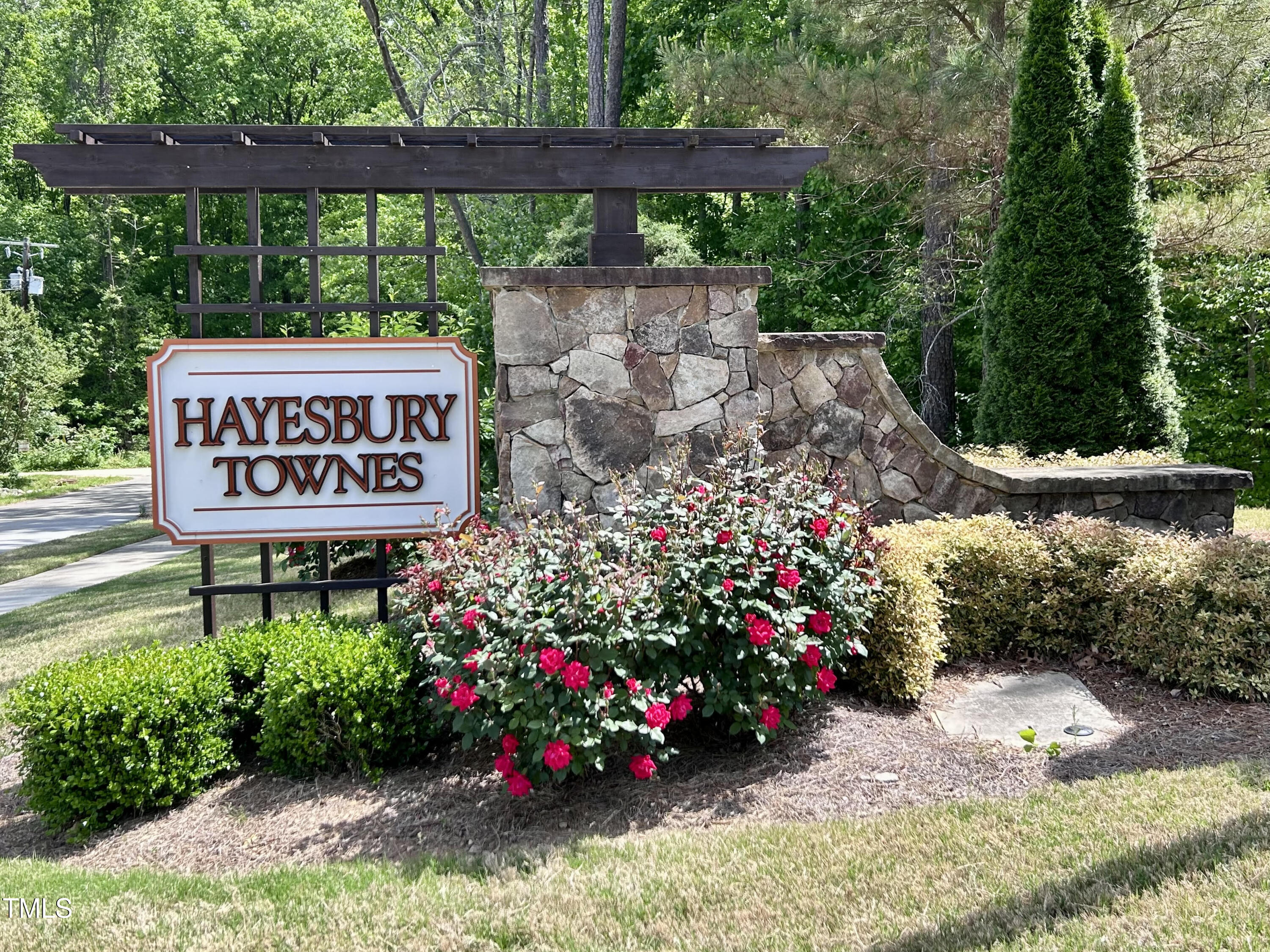 6341 Grace Lily Drive Raleigh, NC 27607 - Photo 3 of 29 a sign that is sitting in front of flowers