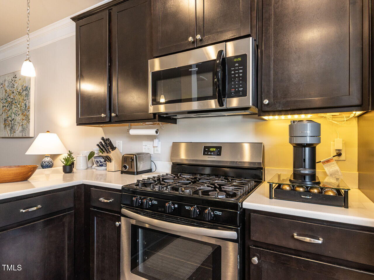 6341 Grace Lily Drive Raleigh, NC 27607 - Photo 8 of 29 a kitchen with stainless steel appliances a stove and a microwave