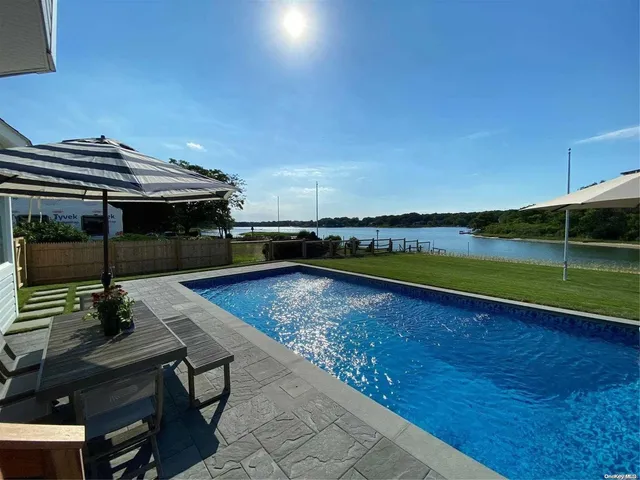 a view of a swimming pool with seating area and furniture