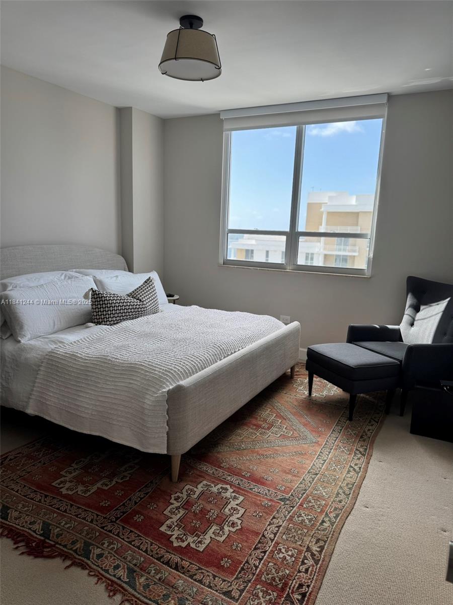 801 Brickell Key Boulevard, Unit 2705 Miami, FL 33131 - Photo 11 of 14 a bedroom with a bed and a window