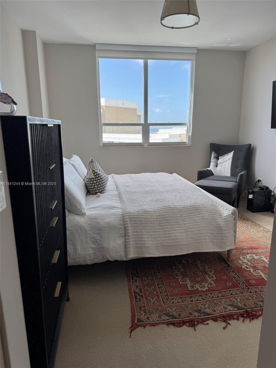 801 Brickell Key Boulevard, Unit 2705 Miami, FL 33131 - Photo 12 of 14 a bedroom with a bed and window