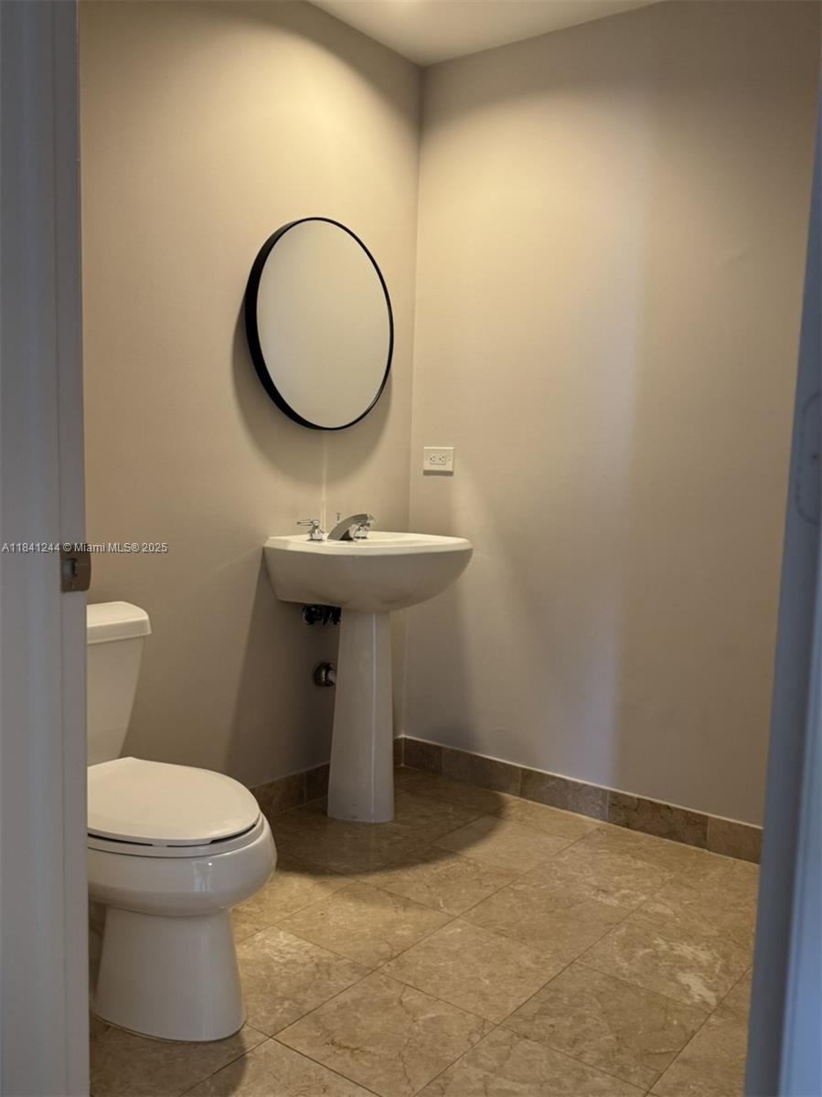 801 Brickell Key Boulevard, Unit 2705 Miami, FL 33131 - Photo 3 of 14 a bathroom with a sink and a mirror