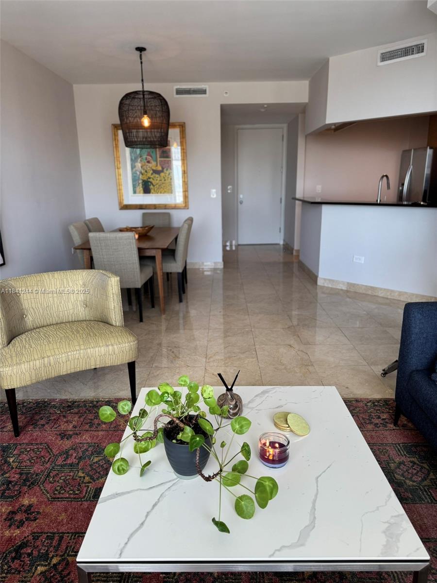 801 Brickell Key Boulevard, Unit 2705 Miami, FL 33131 - Photo 6 of 14 a living room with furniture and a fireplace