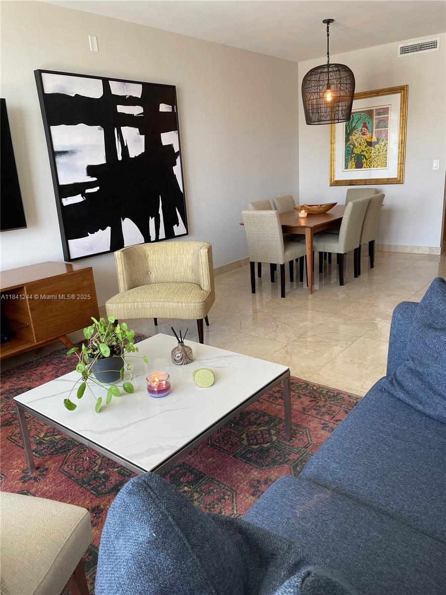 801 Brickell Key Boulevard, Unit 2705 Miami, FL 33131 - Photo 7 of 14 a view of a dining room with furniture and chandelier