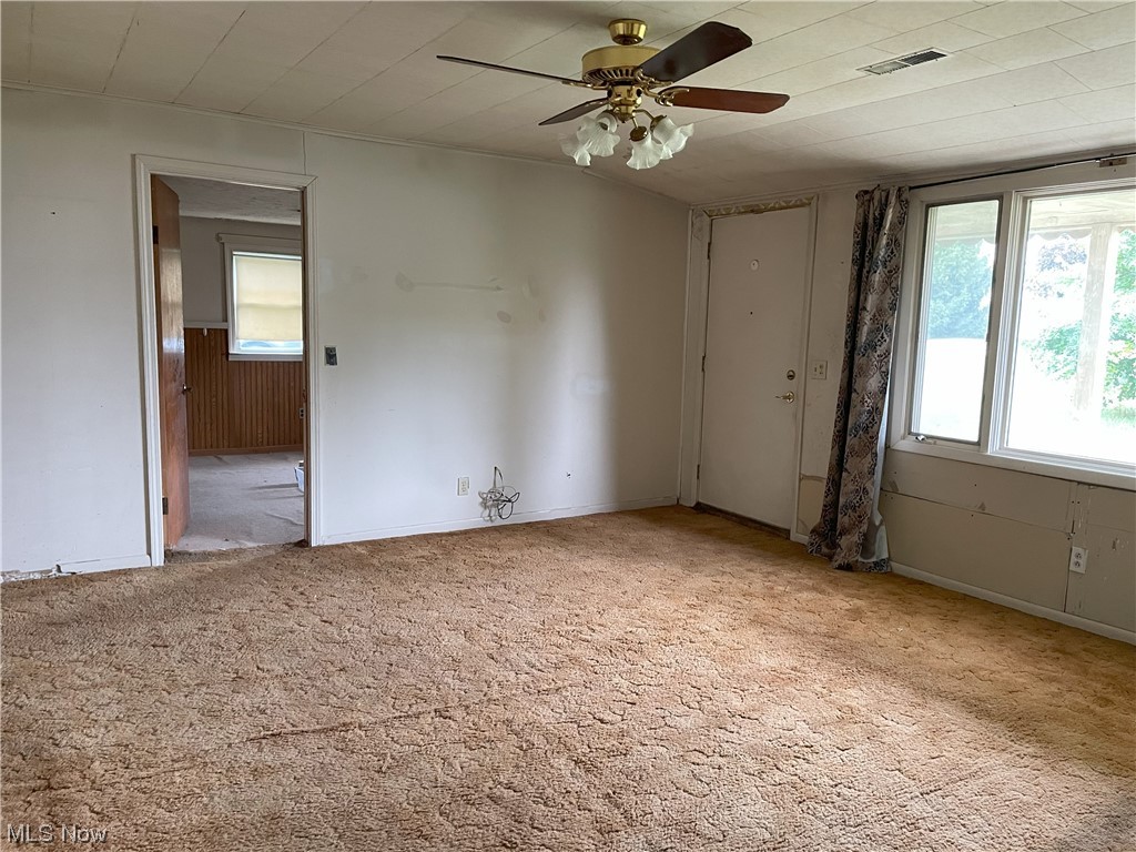 4107 Jaeger Road Lorain, OH 44053 - Photo 9 of 33 Empty living room with light carpet and ceiling fan