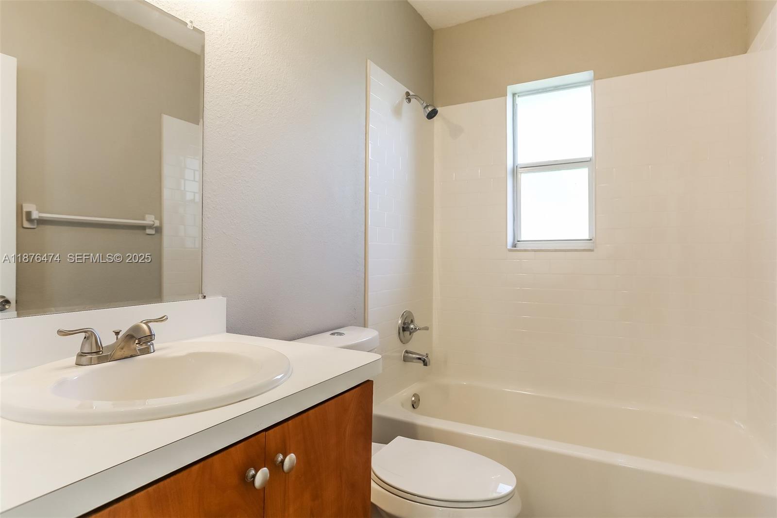 5819 Wilson Street Hollywood, FL 33021 - Photo 13 of 16 a bathroom with a granite countertop sink toilet and bathtub