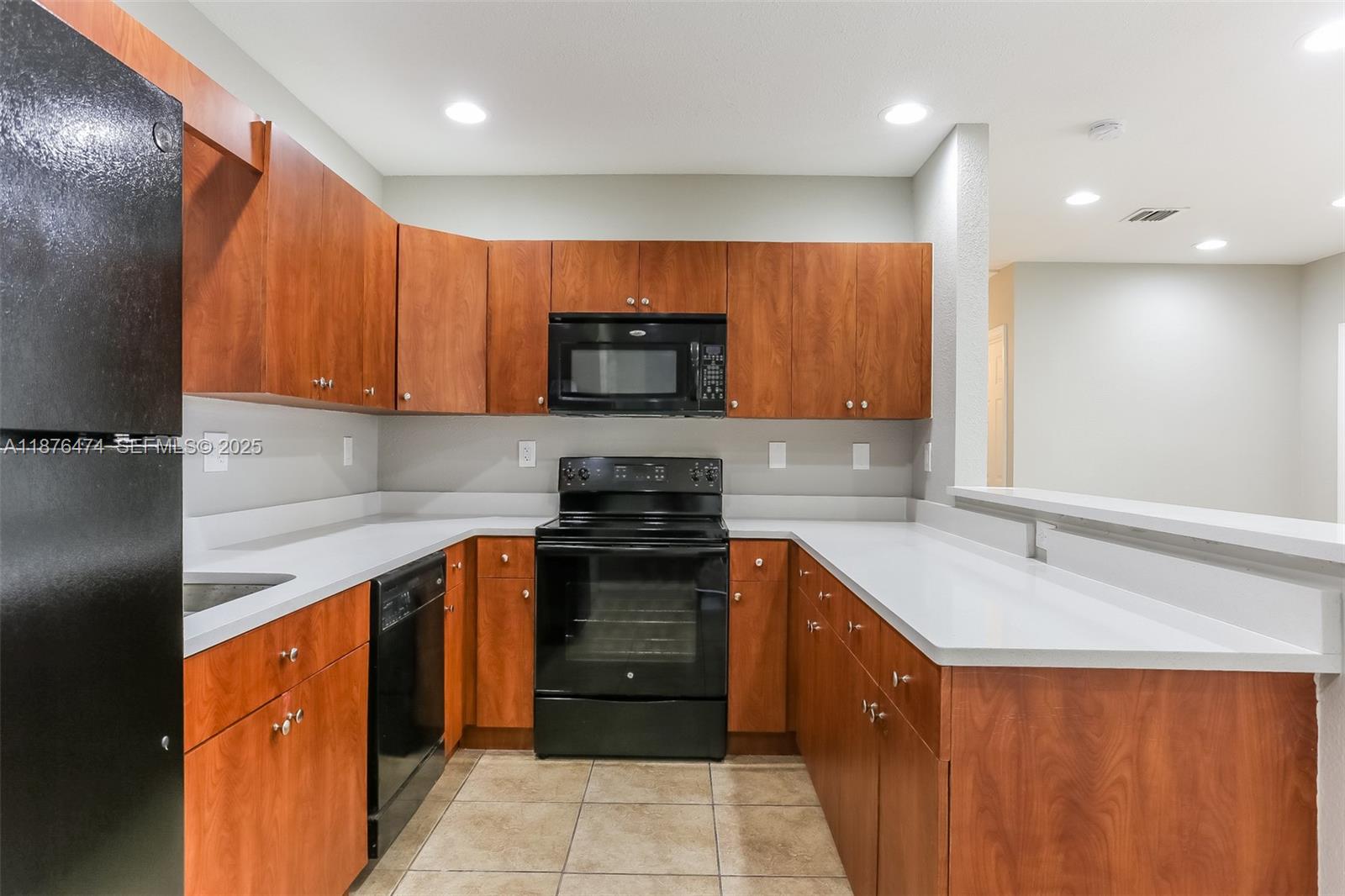 5819 Wilson Street Hollywood, FL 33021 - Photo 6 of 16 a kitchen with stainless steel appliances granite countertop wooden cabinets a stove top oven a sink and dishwasher