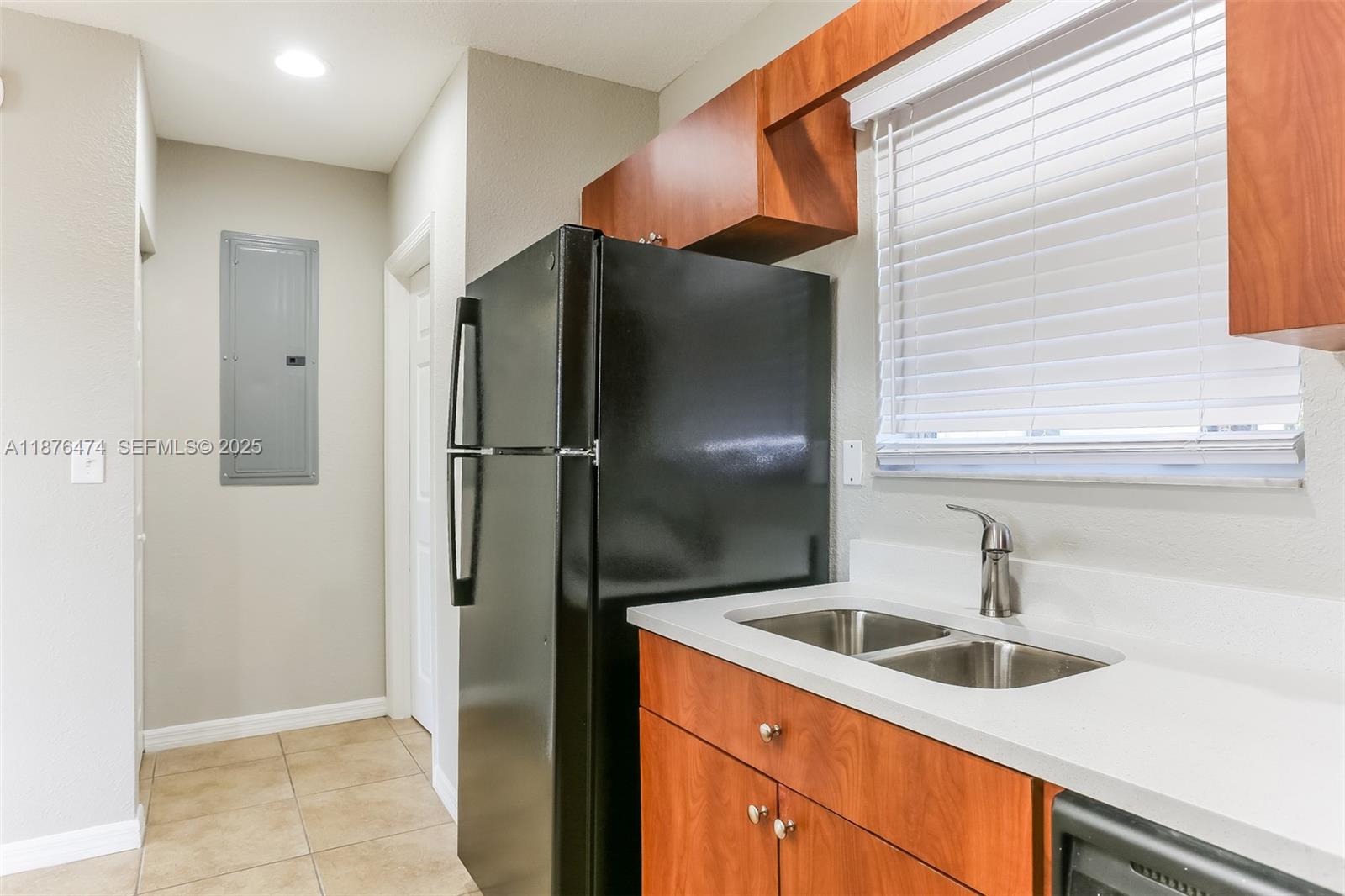 5819 Wilson Street Hollywood, FL 33021 - Photo 7 of 16 a kitchen with a sink and refrigerator