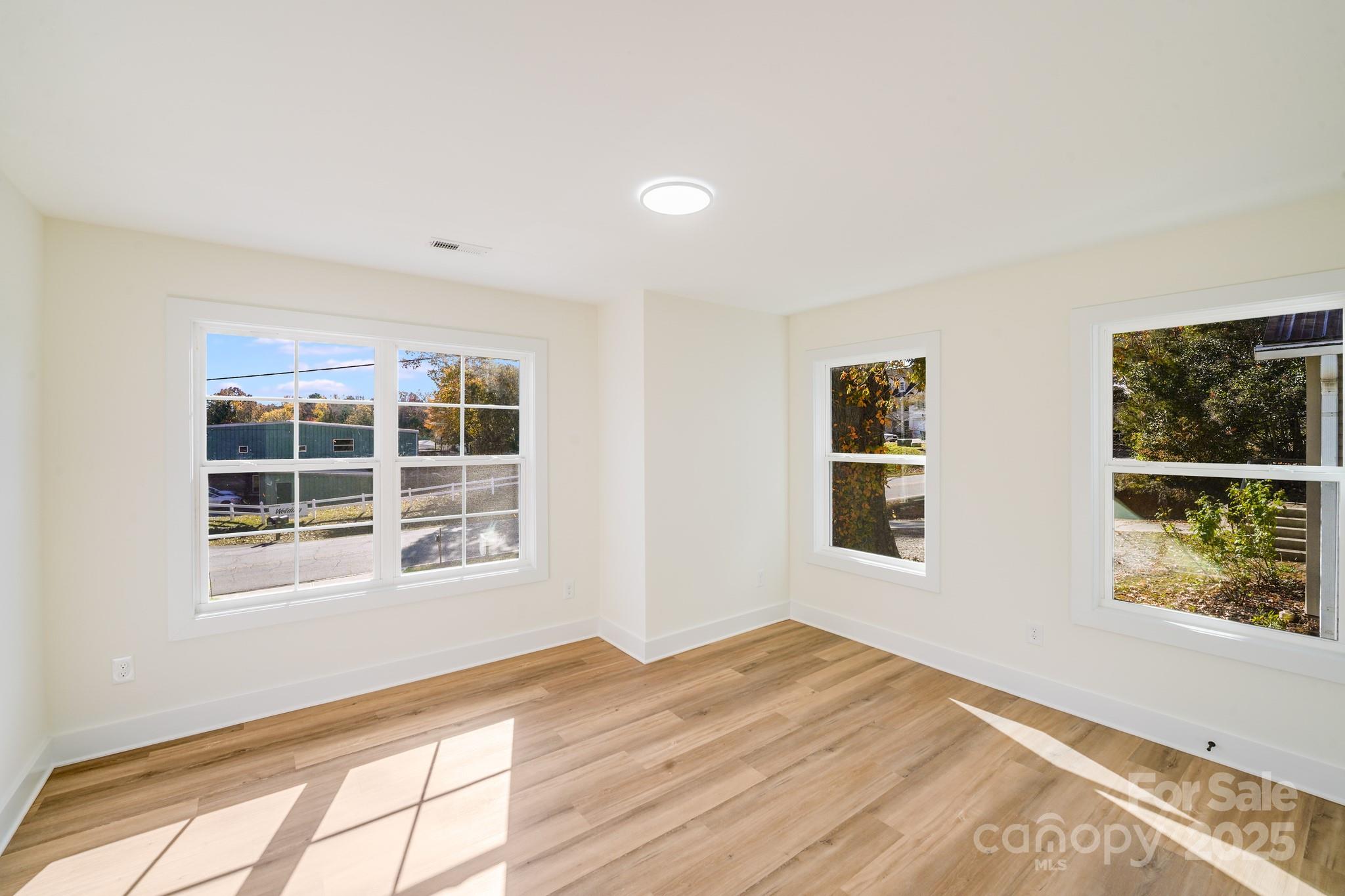 4538 Orphanage Road Concord, NC 28027 - Photo 11 of 14 a view of empty room with wooden floor and fan