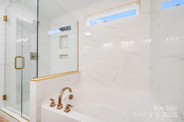 a bathroom with a bathtub and shower