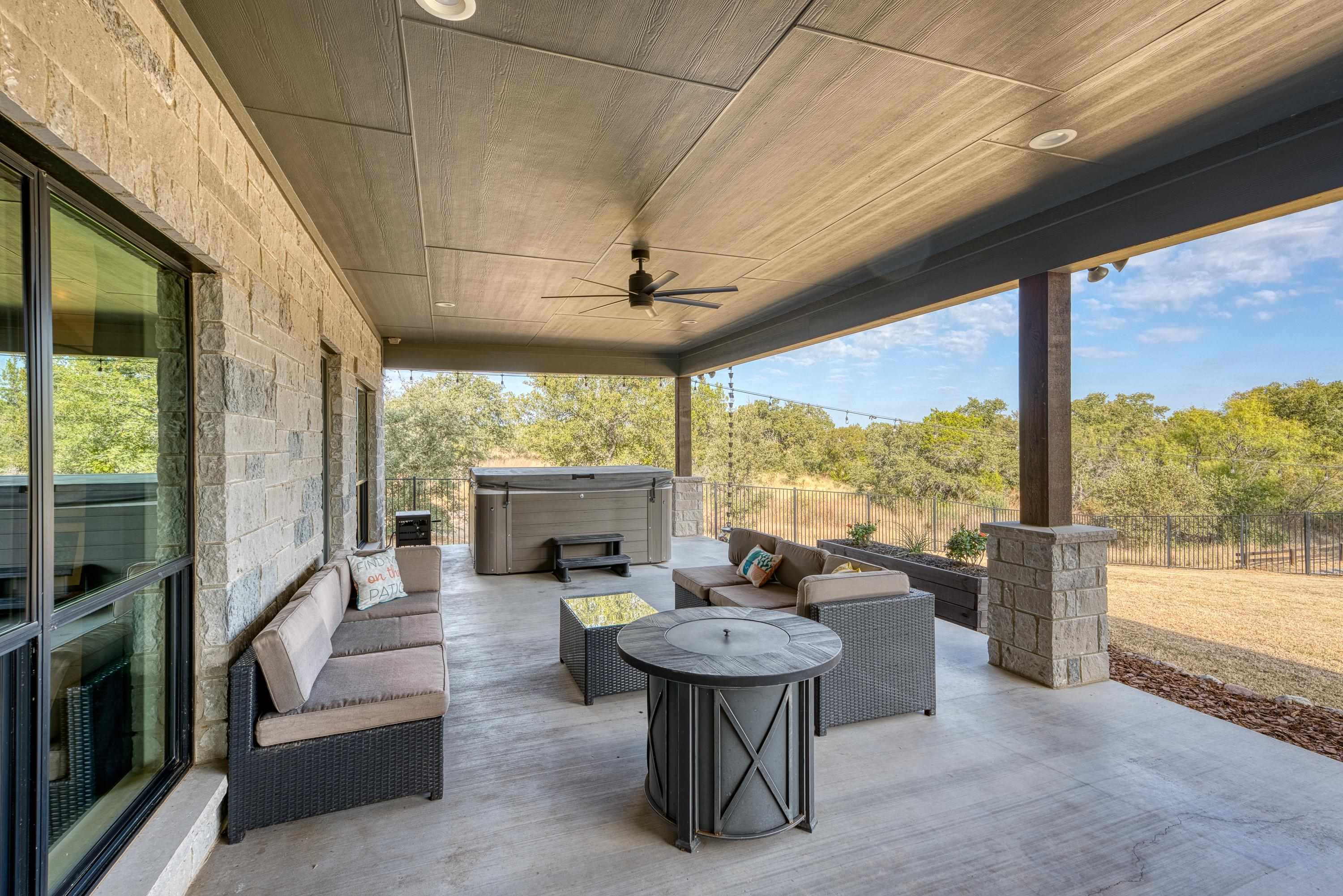 105 Keystone Buchanan Dam, TX 78609 - Photo 19 of 30 a living room with furniture a fireplace and a floor to ceiling window
