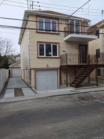 a front view of a house with a street