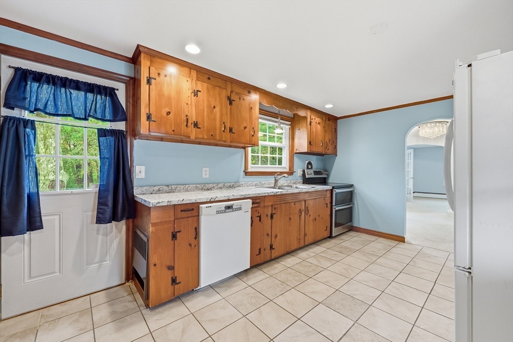 15 Lowell Avenue Holden, MA 01520 - Photo 12 of 42 a kitchen with stainless steel appliances granite countertop a stove a sink and a refrigerator