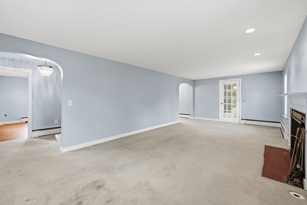 15 Lowell Avenue Holden, MA 01520 - Photo 21 of 42 an empty room with a fireplace and a projector screen