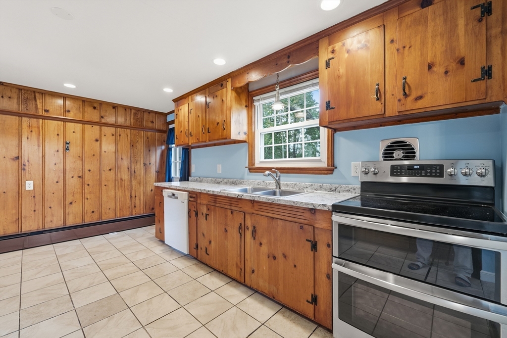 15 Lowell Avenue Holden, MA 01520 - Photo 3 of 42 a kitchen with stainless steel appliances granite countertop a stove a sink and a microwave