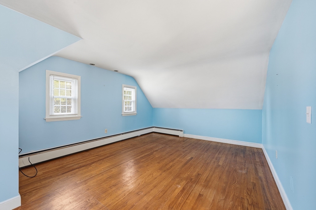 15 Lowell Avenue Holden, MA 01520 - Photo 6 of 42 an empty room with wooden floor and windows