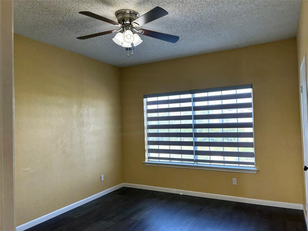 4107 Esters Road Irving, TX 75038 - Photo 8 of 21 Room featuring wood-finish flooring, a window with horizontal blinds, and a ceiling fan with integrated lighting