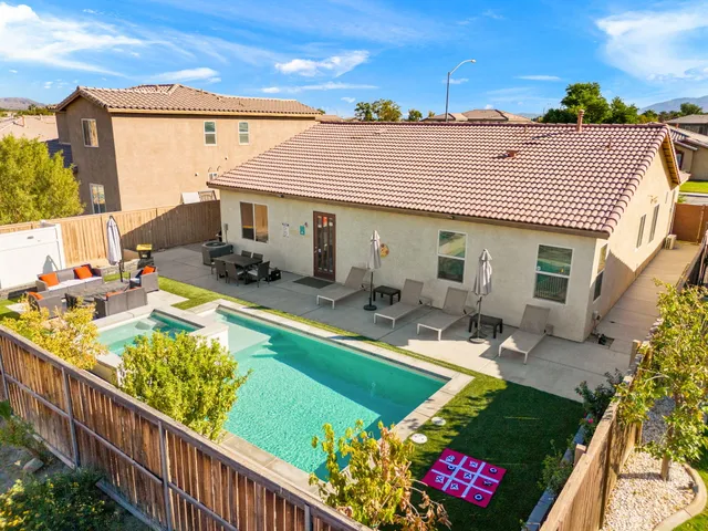 a view of a house with backyard outdoor seating area and furniture