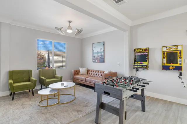 a living room with furniture and a chandelier