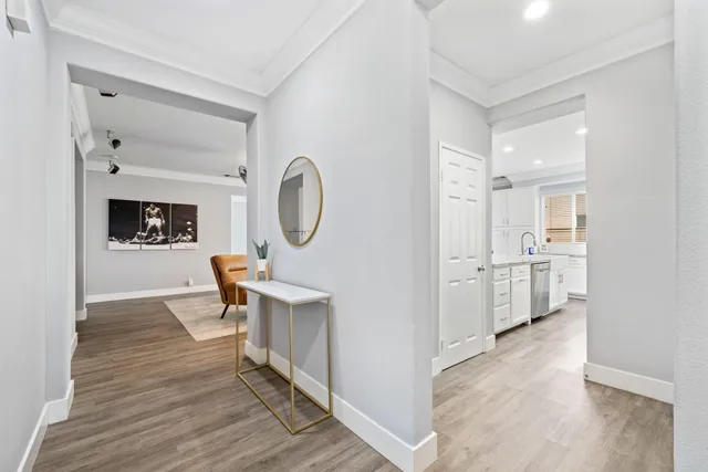 a living room with furniture a mirror and a clock