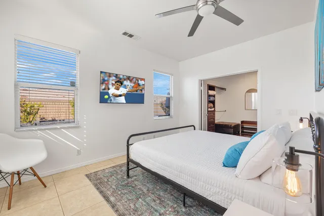 a bedroom with a bed and a chair