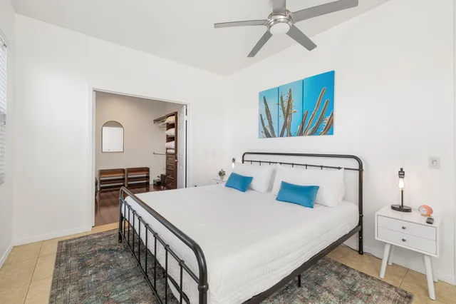 a bedroom with a large bed and a chandelier