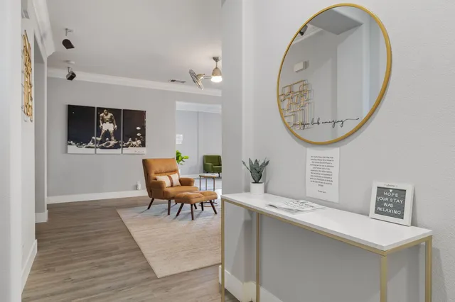 a living room with furniture a table and wooden floor