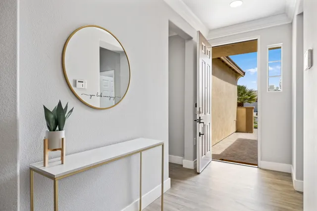 a view of a hallway with wooden floor and entryway