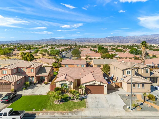 an aerial view of residential houses with outdoor space