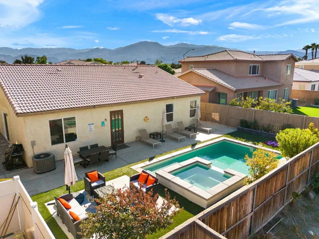 a view of an house with backyard space and balcony