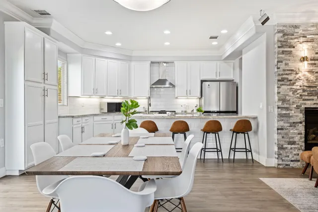 a living room with furniture a table and kitchen view