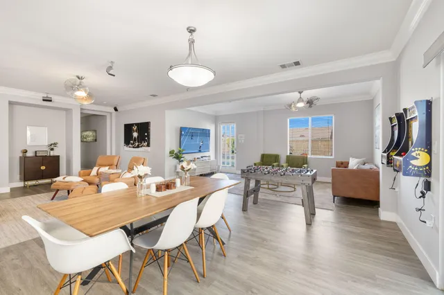 a view of a dining room with furniture and wooden floor
