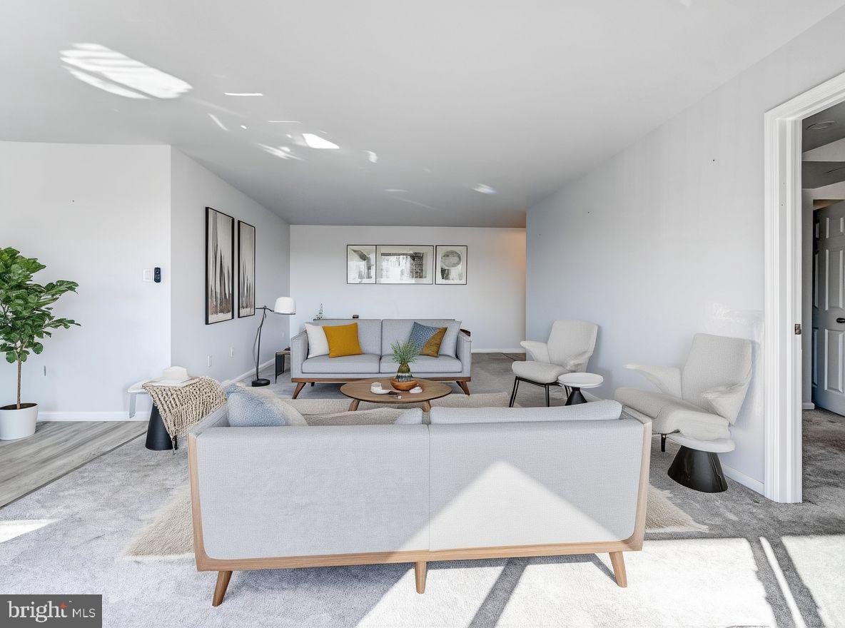 7 Slade Avenue, Unit 718 Pikesville, MD 21208 - Photo 12 of 58 a living room with furniture a table and a potted plant