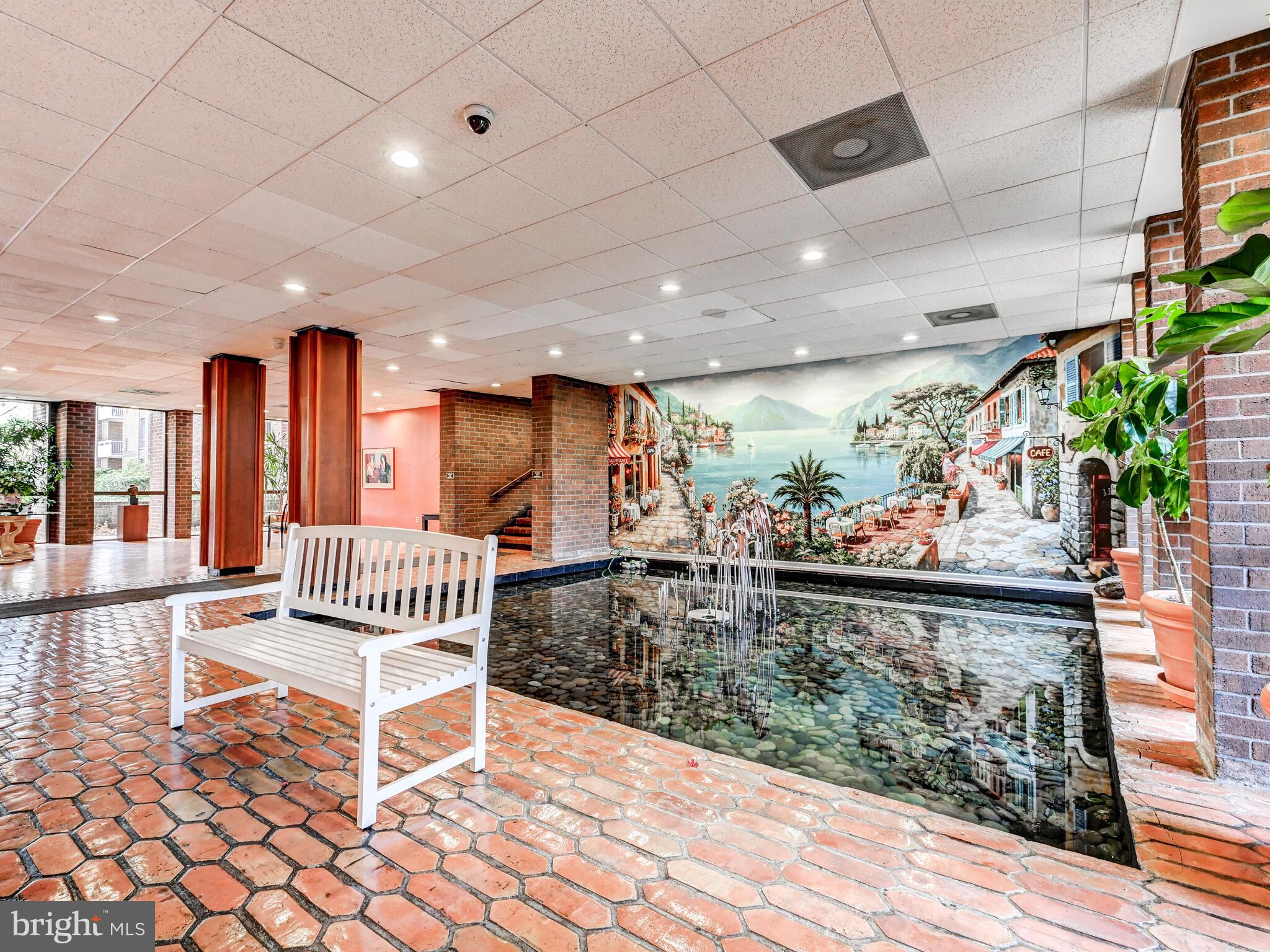 7 Slade Avenue, Unit 718 Pikesville, MD 21208 - Photo 29 of 58 a outdoor space with lots of tables a garden a couches and large window