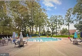 7 Slade Avenue, Unit 718 Pikesville, MD 21208 - Photo 40 of 58 a view of a park with bench and trees