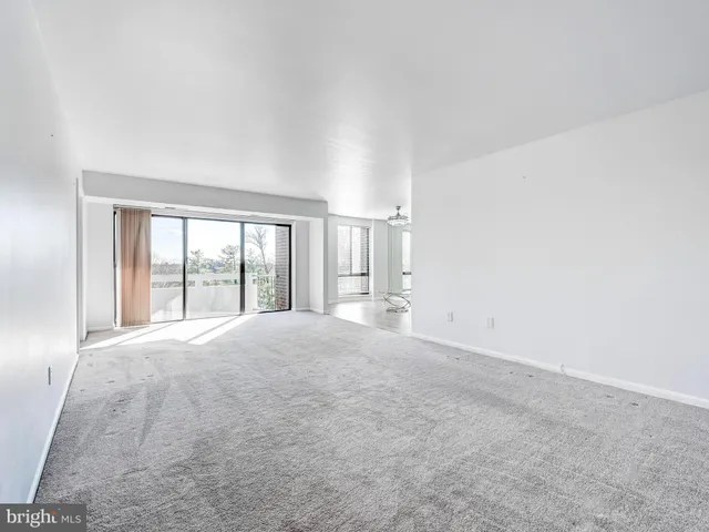 a view of a livingroom with wooden floor and window