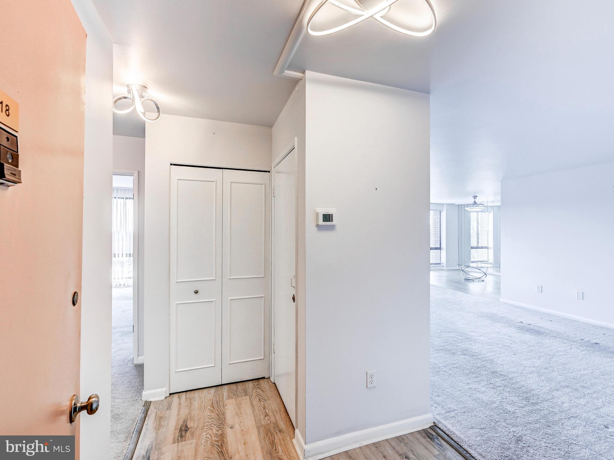 7 Slade Avenue, Unit 718 Pikesville, MD 21208 - Photo 45 of 58 a view of a hallway with wooden floor and closet area