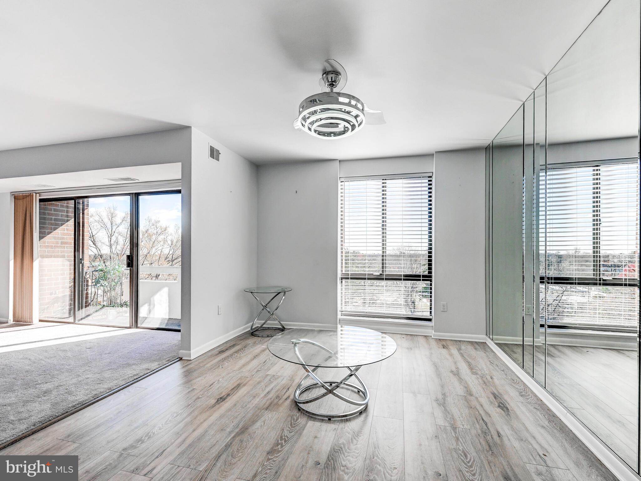 7 Slade Avenue, Unit 718 Pikesville, MD 21208 - Photo 47 of 58 a view of a livingroom with wooden floor and window