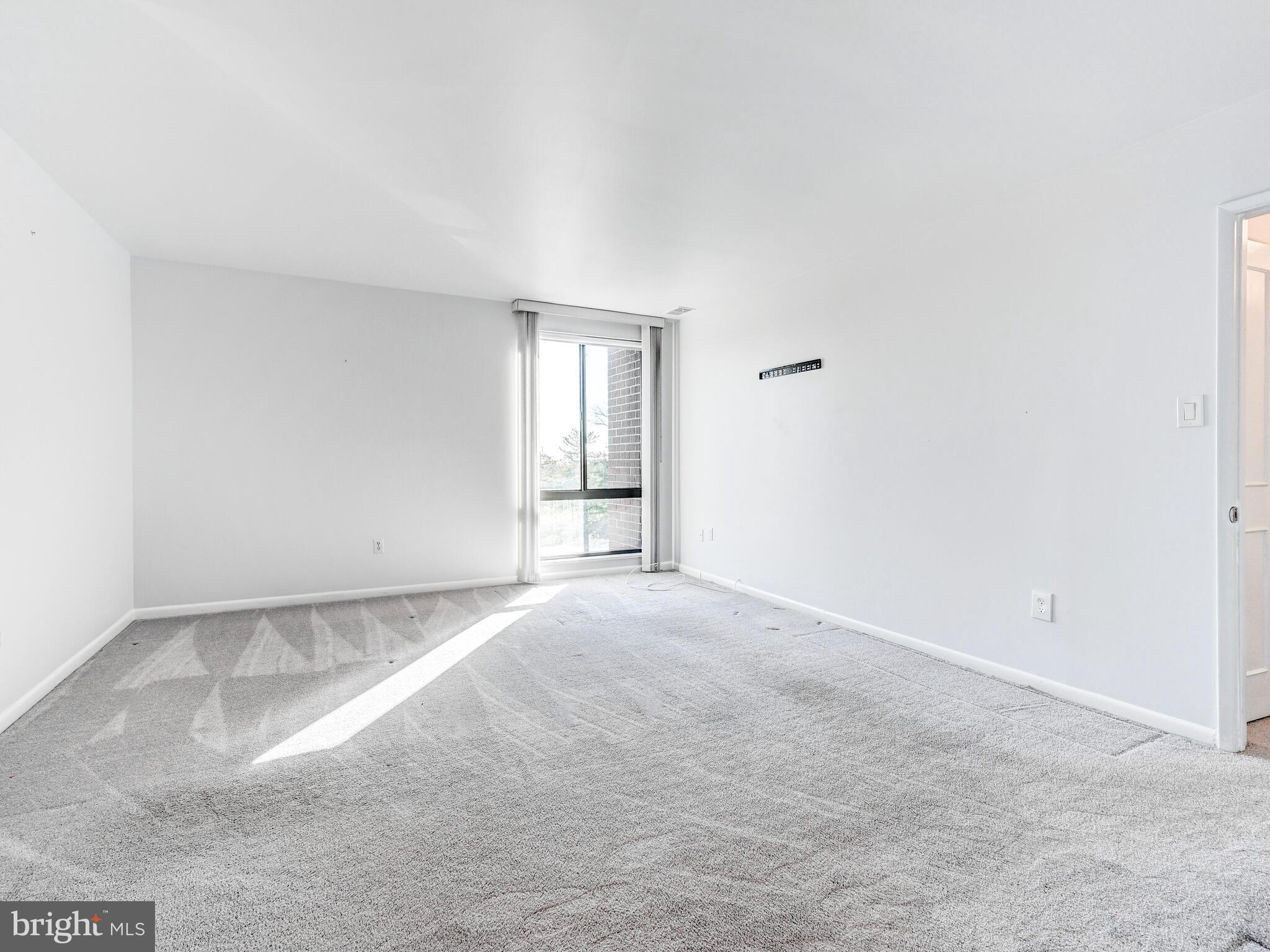 7 Slade Avenue, Unit 718 Pikesville, MD 21208 - Photo 48 of 58 a view of an empty room with a window