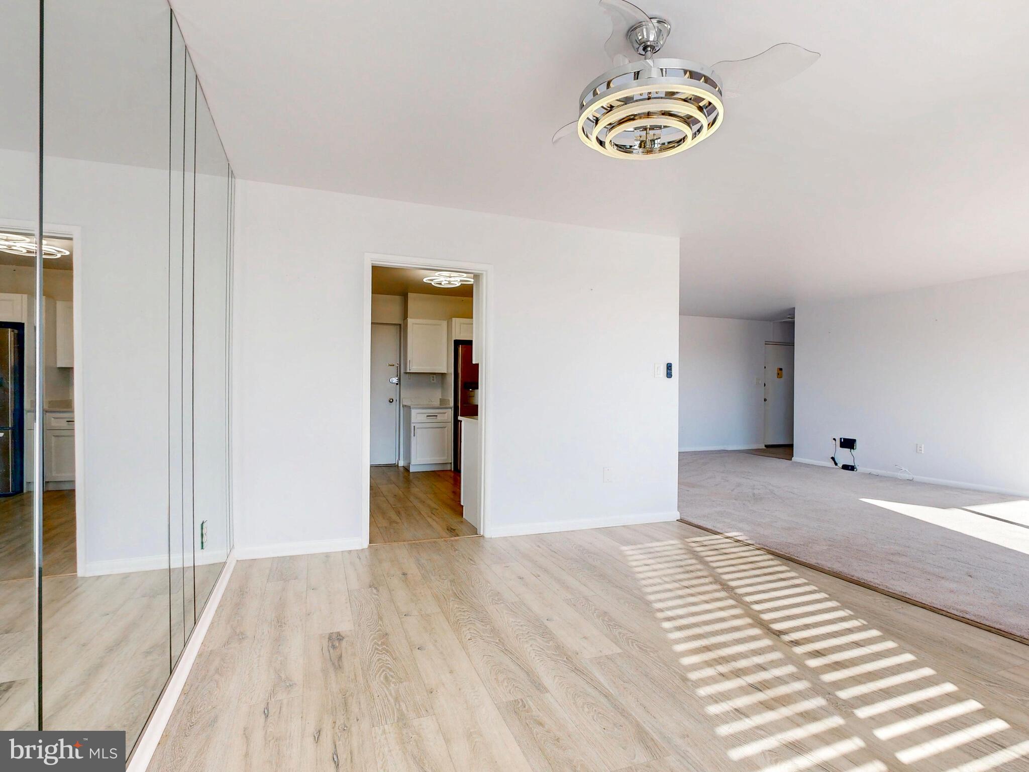 7 Slade Avenue, Unit 718 Pikesville, MD 21208 - Photo 56 of 58 a view of an empty room with wooden floor and a window