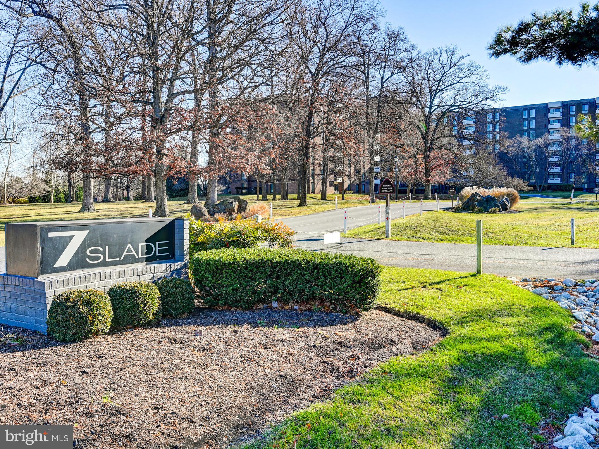 7 Slade Avenue, Unit 718 Pikesville, MD 21208 - Photo 57 of 58 a view of a swimming pool with an outdoor space and seating area