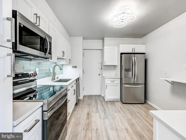 a kitchen with a refrigerator stove and microwave
