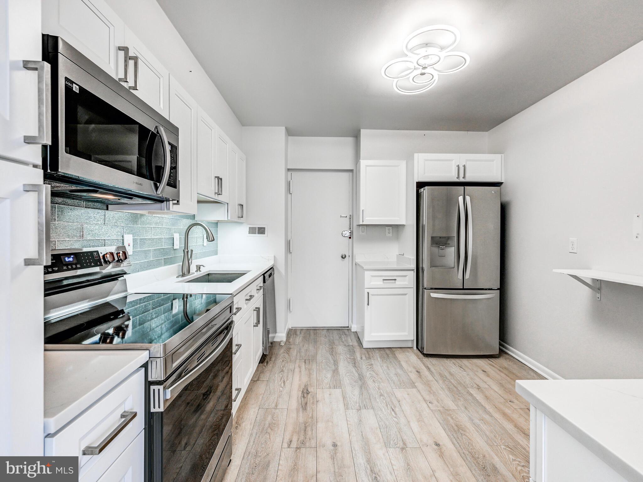 7 Slade Avenue, Unit 718 Pikesville, MD 21208 - Photo 6 of 58 a kitchen with a refrigerator stove and microwave