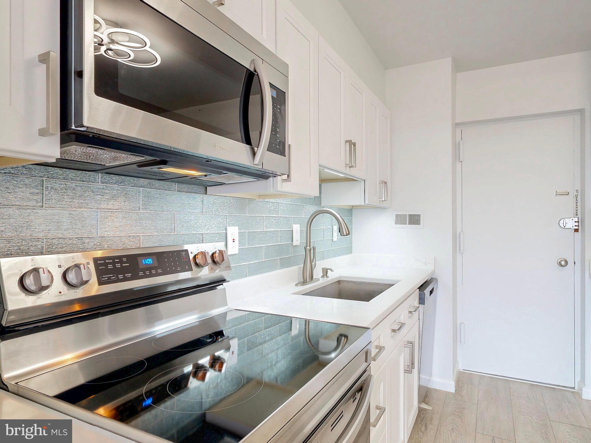 7 Slade Avenue, Unit 718 Pikesville, MD 21208 - Photo 7 of 58 a kitchen with a stove and a microwave