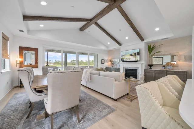 a dining room with furniture and view of kitchen
