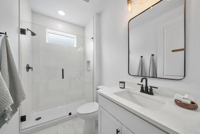 a living room with furniture a window and potted plants