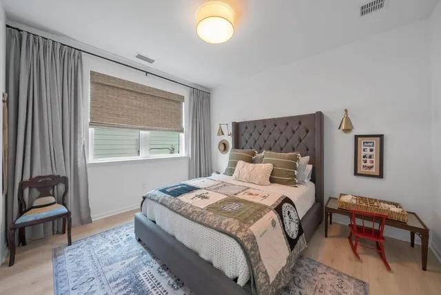a living room with furniture and floor to ceiling windows