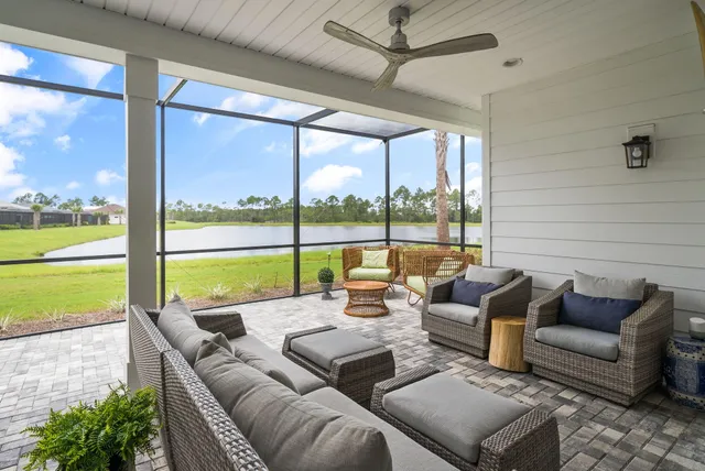 a bathroom with a sink mirror and flowers