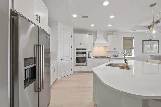 a large kitchen with kitchen island a dining table and chairs