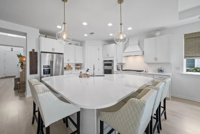 a kitchen with stainless steel appliances a refrigerator sink and cabinets